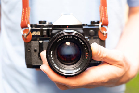 Saint Petersburg, Russia - 08/27/2020: old black camera close-up in the hands of a manのeditorial素材