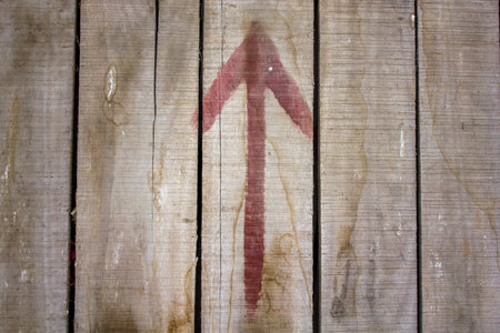 old gray dusty dirty wooden planks with cracks and red arrow. dirt spots on wooden boards. natural surface textureの写真素材