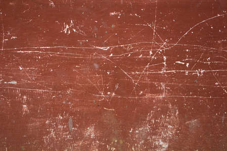 old red-brown wall with deep white scratches and stains. rough texture.