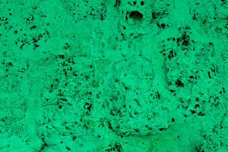 green porous volcanic stone close up. rough natural texture surfaceの写真素材