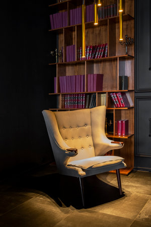 Saint Petersburg, Russia - 07.06.2020: empty white armchair on the background of a vintage library with red booksのeditorial素材