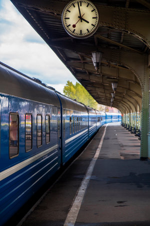 Saint Petersburg, Russia - 27.08.2020 vintage iron platform with clock, railway station with blue...