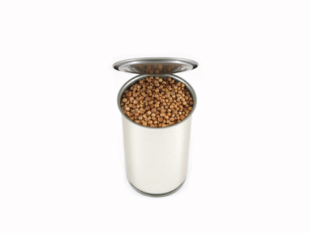 Coriander seeds in can on white background の写真素材