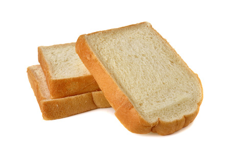 stack of sliced American white bread on white backgroundの写真素材