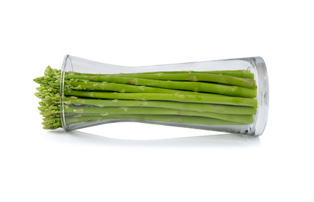 fresh green asparagus in glass on white backgroundの写真素材