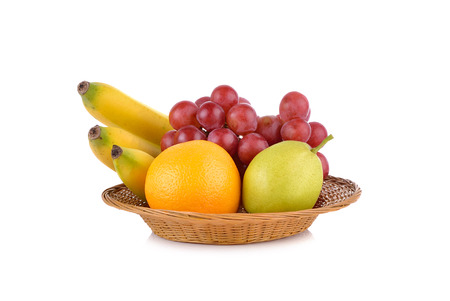 mixed fruit, banana, orange, pear, grape in basket on white backgroundの写真素材