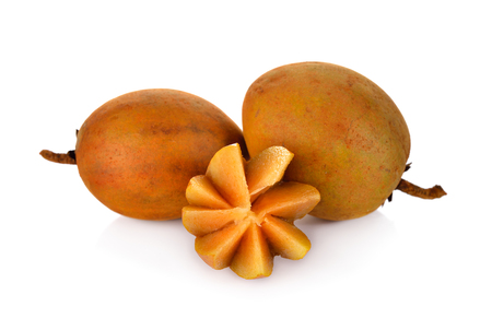 whole and carving ripe sapodilla with stem on white backgroundの写真素材