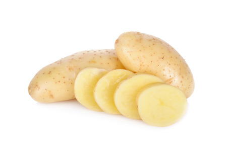 whole and sliced raw unpeeled potato on white backgroundの写真素材