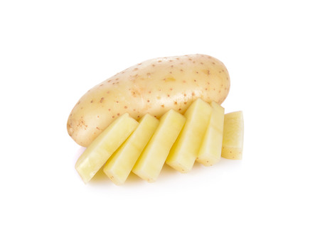 whole and sliced raw unpeeled potato on white backgroundの写真素材