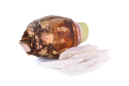 whole and portion cut raw taro on white backgroundの写真素材