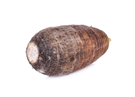unpeeled raw taro on white backgroundの写真素材