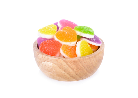 colorful jelly candy in wooden bowl and on white backgroundの写真素材