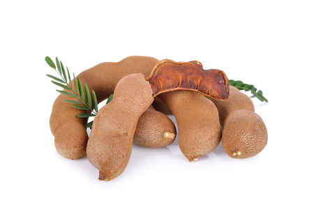 ripe sweet tamarind with leaves on white backgroundの写真素材