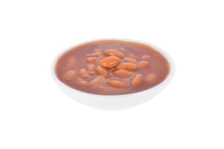 baked beans in tomato sauce in white bowl on white backgroundの写真素材
