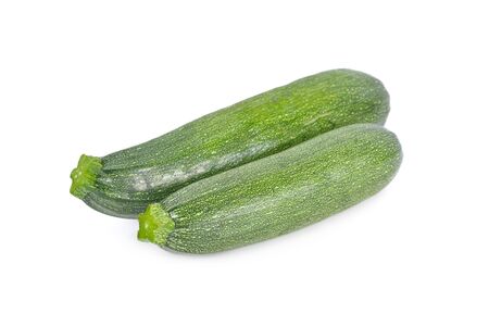 whole unpeeled fresh zucchini on white backgroundの写真素材