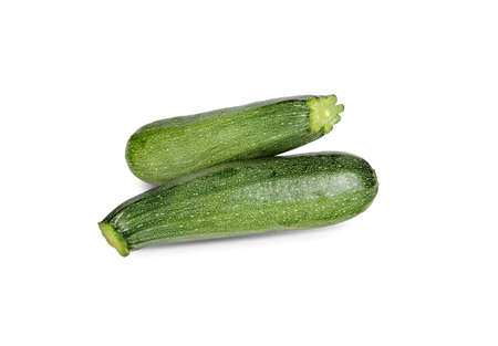 Whole unpeeled fresh zucchini on whiteの写真素材
