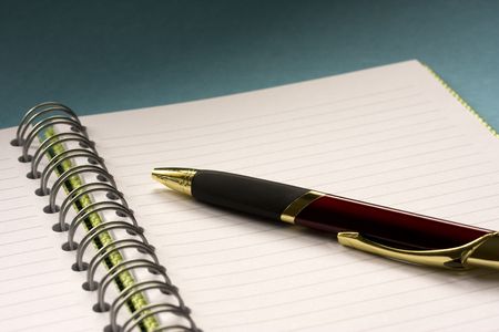 Blank green spiral notepad with burgundy penの写真素材