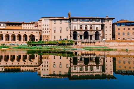 Promenade street of the Arno river in Florence. Ancient buildings and their reflections in the water...