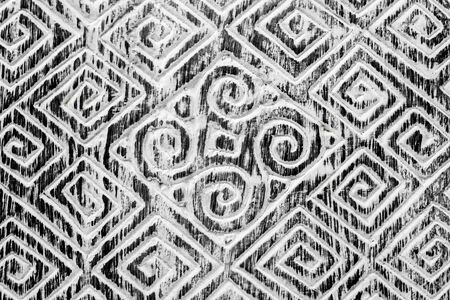 Black and white textured hand-carved wooden background. The spiral patterns. Folk art of the inhabitants of Bali.の写真素材