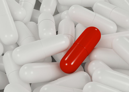Red capsule stand alone on white capsules, healthcare concept.の写真素材
