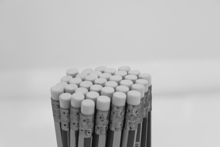 eraser pencils row concept, object isolated, white black backgroundの写真素材