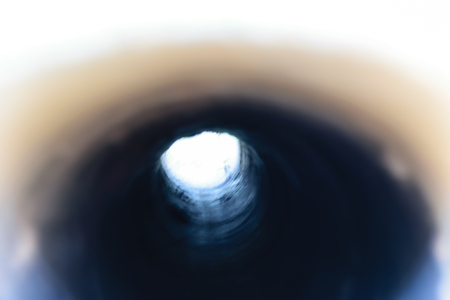 Blurring image of drain dirty water under of road in Thailandの写真素材