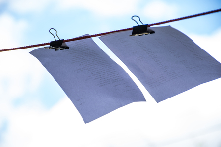 clipping papers on string  with blue sky backgroundの写真素材