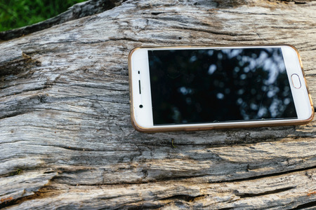 smartphone put on surface of old wooden, close up ,old wooden backgroundの写真素材