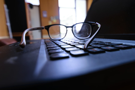 Thirdly, the emphasis on shooting glasses on a black notebook keyboard. Represents the work,...