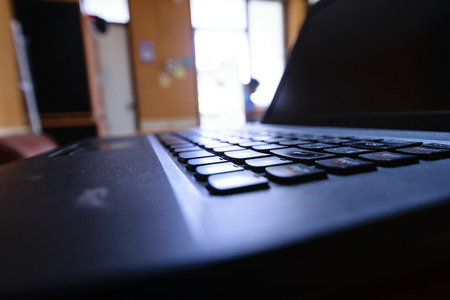 Thirdly, the emphasis on shooting black notebook keyboard. Represents the work, technology and communications in the workplace.の写真素材