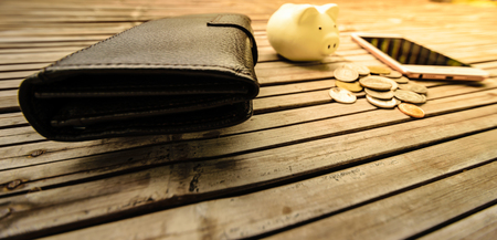 Black leather wallet, placed on a table, bamboo is old Bill paid for the goods, or buying used.の写真素材
