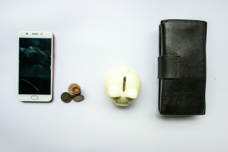 Storage saving with a dark black leather and white piggy bank.Represent the richness in the future.Concept image isolated white backgroundの写真素材