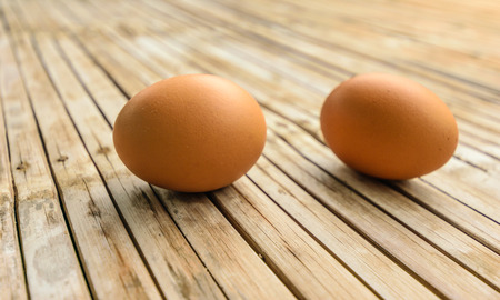 Fresh egg meals To make a breakfast.Have a high nutritional value,including high cholesterol has been put on the bamboo wooden table, look like natural.の写真素材