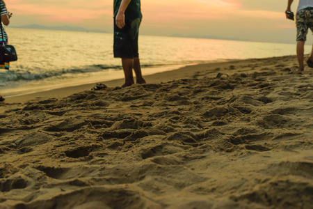 beach walk with sunset background,walk on sea beach on happy holidayの写真素材