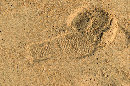 footprint on gold sand beach background texture ,close up to sand ground,nature concept background textureの写真素材