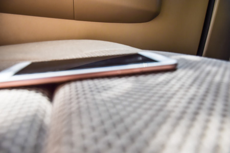 Blurred smartphone on sofar in carの写真素材