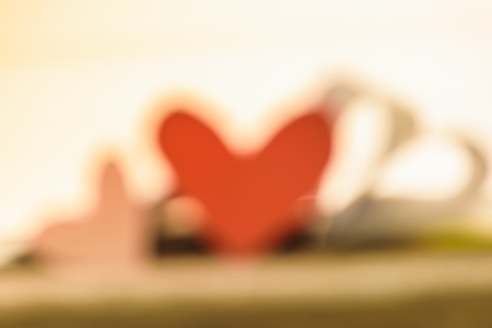 Note love on paper with old wooden background, and pink heart shape above it, Valentine's day texture background concept.の写真素材