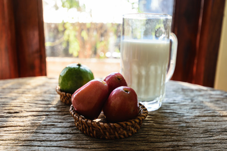 Milk, hot tea and fruit for breakfast on old wooden table , menu healthy concept.の写真素材
