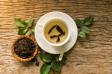 hot tea on wooden table, feeling warm heart in to love, moring fresh daily to working, feeling lovely concept. start to good working.の写真素材