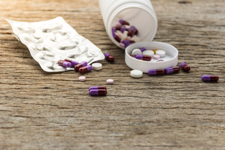 Antibiotic smart use for medicine , drug and capsule put on old wooden table, health care concept,close up tablet and capsule drug.の写真素材
