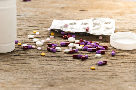 Antibiotic smart use for medicine , drug and capsule put on old wooden table, health care concept,close up tablet and capsule drug.の写真素材