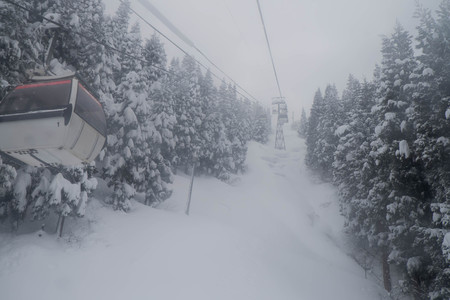 Cable car in snow stromの写真素材