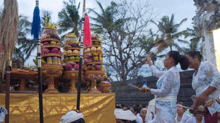 Bali, Indonesia - september 2017 : Balinese people with their son is praying fervently during...