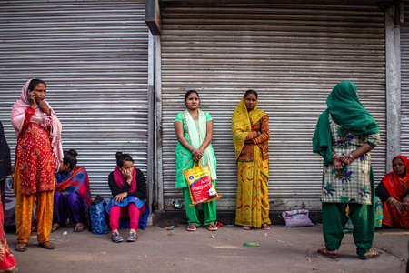 New Delhi, Delhi/ India- May 17 2020: People waiting at the bus stop with their children to get migrated by the Government during corona virus epidemic.のeditorial素材