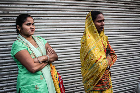 New Delhi, Delhi/ India- May 17 2020: People waiting at the bus stop with their children to get migrated by the Government during corona virus epidemic.のeditorial素材