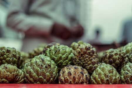 stacks of sugar apple or custard apple at the traditional marketplace in Delhi