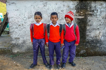 Almora, Uttrakhand / India- May 25 2020 : Group of young kids returning from school with red and blue uniformのeditorial素材