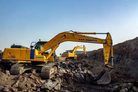 Mumbai, Maharastra, India - May 22 2020 : Two JCB cranes working at a mine near mumbai