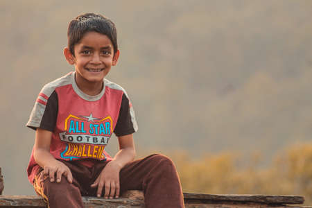 Almora, Uttrakhand, India- May 22 2020: A travel portrait of a young kid smiling looking into the cameraのeditorial素材