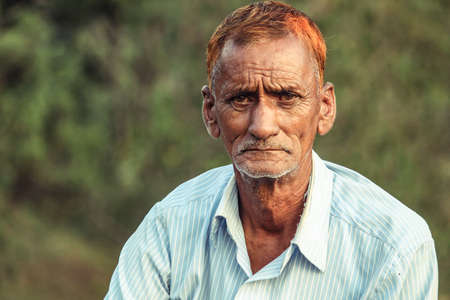 Almora, Uttrakhand, India- May 22 2020: A travel portrait of an old person looking into the camera, wrinkles all over the face and red hair.のeditorial素材